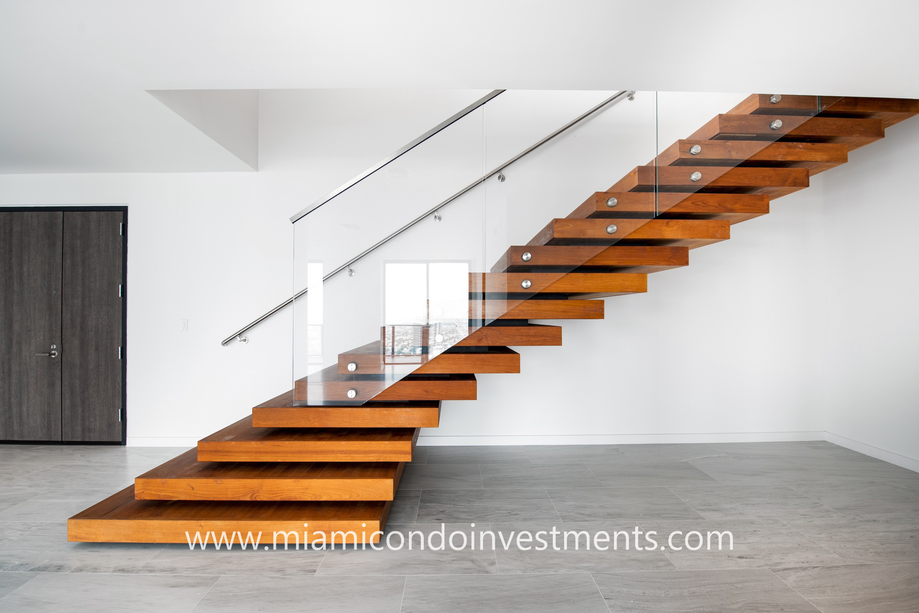 wooden staircase with glass railing
